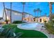 An inviting backyard with a sparkling pool, tropical landscaping, and a guesthouse, perfect for relaxation at 2694 Caumsett Ct, Las Vegas, NV 89117