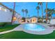 Relaxing backyard with pool, palms, and a guesthouse, offering a serene outdoor living space at 2694 Caumsett Ct, Las Vegas, NV 89117