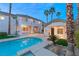 Backyard oasis with a shimmering pool, mature palms, and a charming guesthouse, perfect for entertaining at 2694 Caumsett Ct, Las Vegas, NV 89117