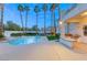 Beautiful backyard featuring a swimming pool, hot tub, outdoor kitchen and desert landscaping at 2694 Caumsett Ct, Las Vegas, NV 89117