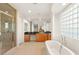 Bright bathroom features a glass enclosed shower and wooden cabinets at 2694 Caumsett Ct, Las Vegas, NV 89117