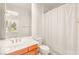 Bright bathroom featuring a white sink with wood cabinets, a toilet, and a shower with a white curtain at 2694 Caumsett Ct, Las Vegas, NV 89117