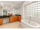 Bright bathroom with cabinets, tile floors, and soaking tub at 2694 Caumsett Ct, Las Vegas, NV 89117