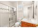 Clean bathroom featuring glass-enclosed shower, white toilet, and vanity with chrome fixtures at 2694 Caumsett Ct, Las Vegas, NV 89117