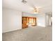 A spacious bonus room featuring carpet, built-in shelves, and a ceiling fan, ready for your personal touch at 2694 Caumsett Ct, Las Vegas, NV 89117