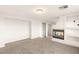 Bonus room features a modern fireplace, light gray carpet, and built-in shelving at 2694 Caumsett Ct, Las Vegas, NV 89117