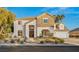Beautiful two-story home showcasing a stone facade, lush landscaping, and an attached two-car garage at 2694 Caumsett Ct, Las Vegas, NV 89117