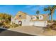 Elegant two-story home with a spacious driveway, multi-car garage and mature landscaping at 2694 Caumsett Ct, Las Vegas, NV 89117