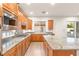 Spacious kitchen featuring granite countertops, stainless steel appliances and breakfast bar at 2694 Caumsett Ct, Las Vegas, NV 89117