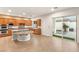 Modern kitchen with hardwood floors, granite countertops, stainless steel appliances, and sliding door to patio at 2694 Caumsett Ct, Las Vegas, NV 89117