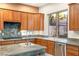 Kitchen featuring granite countertops, stainless steel appliances, and wood cabinets at 2694 Caumsett Ct, Las Vegas, NV 89117