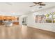 Bright living room featuring a large window with backyard views and hardwood floors at 2694 Caumsett Ct, Las Vegas, NV 89117