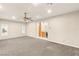 Living room with neutral walls, carpet flooring, and a view into the kitchen at 2694 Caumsett Ct, Las Vegas, NV 89117