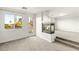 Bright living room with modern fireplace, light gray carpet, and a window to a balcony overlooking palm trees at 2694 Caumsett Ct, Las Vegas, NV 89117