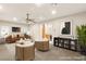 Staged living room with elegant furniture and decor, flowing into a kitchen area at 2694 Caumsett Ct, Las Vegas, NV 89117