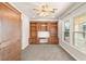 Well-lit office featuring a ceiling fan, built-in wooden shelves and cabinets, and sunlit windows at 2694 Caumsett Ct, Las Vegas, NV 89117