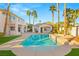 Inviting backyard pool and spa surrounded by palm trees, creating a serene outdoor oasis at 2694 Caumsett Ct, Las Vegas, NV 89117