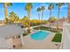 Aerial view of the pool and spa, with lush landscaping and palm trees, enhancing the backyard oasis at 2694 Caumsett Ct, Las Vegas, NV 89117