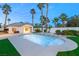 Backyard pool and spa area surrounded by lush landscaping and a private detached structure at 2694 Caumsett Ct, Las Vegas, NV 89117