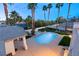 Aerial view of pool with spa and outdoor living space, with a view of the well maintained landscaping at 2694 Caumsett Ct, Las Vegas, NV 89117