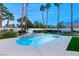 Private backyard pool with a spa and mature palm trees, creating a tranquil retreat at 2694 Caumsett Ct, Las Vegas, NV 89117