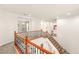 Upper level with a staircase featuring wooden banisters with black wrought iron spindles at 2694 Caumsett Ct, Las Vegas, NV 89117