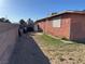 Exterior shot of backyard featuring a dirt area and block wall as well as some trash containers at 2700 Spear St, North Las Vegas, NV 89030