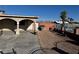 Front exterior view of a single story home with a gated entry and a barbecue sitting on the rocked area at 2700 Spear St, North Las Vegas, NV 89030