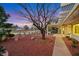 Charming backyard featuring mature landscaping, covered patio, and scenic golf course views at 2817 Billy Casper Dr, Las Vegas, NV 89134
