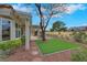 Charming backyard featuring artificial turf, desert landscaping, and covered patio with golf course views at 2817 Billy Casper Dr, Las Vegas, NV 89134