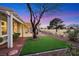Charming backyard featuring artificial turf, desert landscaping, and covered patio with golf course views at 2817 Billy Casper Dr, Las Vegas, NV 89134