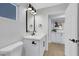 Bright bathroom with a modern vanity, black fixtures, and a stylish mirror at 2817 Billy Casper Dr, Las Vegas, NV 89134