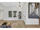 Bright and inviting entryway with modern lighting, hardwood floors, and stylish front door enhancing the home's curb appeal at 2817 Billy Casper Dr, Las Vegas, NV 89134