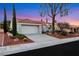 Well-maintained single-story home boasts a two-car garage, mature trees, and xeriscaped front yard at 2817 Billy Casper Dr, Las Vegas, NV 89134