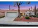 Inviting single-story home featuring a two-car garage, manicured front yard, and a classic tile roof at 2817 Billy Casper Dr, Las Vegas, NV 89134