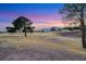 Scenic view of golf course with lush greenery and mountain views at sunset at 2817 Billy Casper Dr, Las Vegas, NV 89134