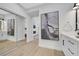 Well-lit hallway with mirrored closet leading into the living room and bathroom at 2817 Billy Casper Dr, Las Vegas, NV 89134