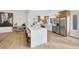 Bright kitchen with modern island and bar stools, appliances including stainless steel refrigerator and oven at 2817 Billy Casper Dr, Las Vegas, NV 89134