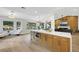 Bright kitchen with modern island, sitting area with bay window, dining area, and living room at 2817 Billy Casper Dr, Las Vegas, NV 89134