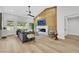 Cozy living room featuring a paneled accent wall, fireplace, and sliding glass doors leading to the backyard at 2817 Billy Casper Dr, Las Vegas, NV 89134