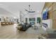 Open-concept living room with breakfast bar, fireplace, and sliding glass doors leading to the backyard at 2817 Billy Casper Dr, Las Vegas, NV 89134