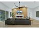 Spacious living room featuring a gray sofa, wood accent wall, and modern electric fireplace at 2817 Billy Casper Dr, Las Vegas, NV 89134