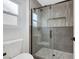 A close up of a modern shower with neutral tiling and sleek glass doors at 2817 Billy Casper Dr, Las Vegas, NV 89134