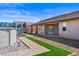 Backyard view showing patio, brick trim, gravel and partial pool structure at 340 Domingo St, Pahrump, NV 89048