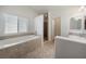 Bright bathroom featuring a soaking tub, walk-in shower and vanity with sink at 340 Domingo St, Pahrump, NV 89048