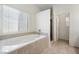 Bright bathroom showcasing a tiled tub and a glass-enclosed shower at 340 Domingo St, Pahrump, NV 89048