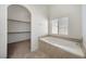 Corner view of a bathtub with tile surround, next to a walk-in closet at 340 Domingo St, Pahrump, NV 89048
