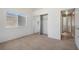 Cozy bedroom featuring neutral walls, carpet, a mirrored closet and natural light at 340 Domingo St, Pahrump, NV 89048