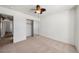 This bedroom features carpet flooring, ceiling fan and access to a closet and the adjacent room at 340 Domingo St, Pahrump, NV 89048