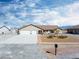 Exterior of a tan single-Gathering home, featuring a three-car garage and desert landscaping at 340 Domingo St, Pahrump, NV 89048